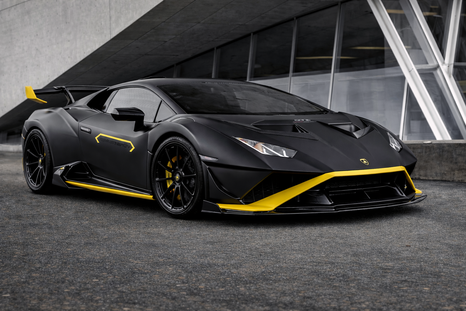 A&A Car Detailing in Montreal showcasing a matte black Lamborghini Huracan with yellow accents