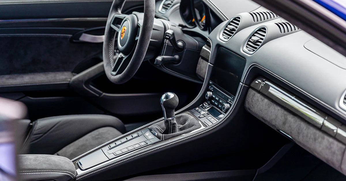 Luxury car interior after professional detailing in Montreal – clean dashboard, steering wheel, and gear shift.