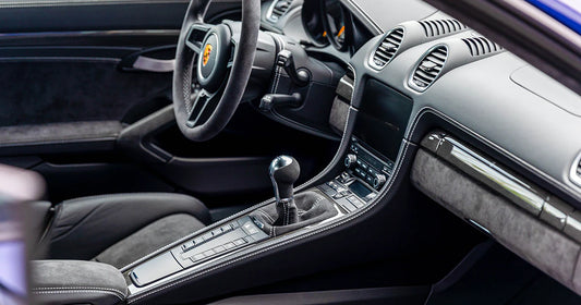 Luxury car interior after professional detailing in Montreal – clean dashboard, steering wheel, and gear shift.